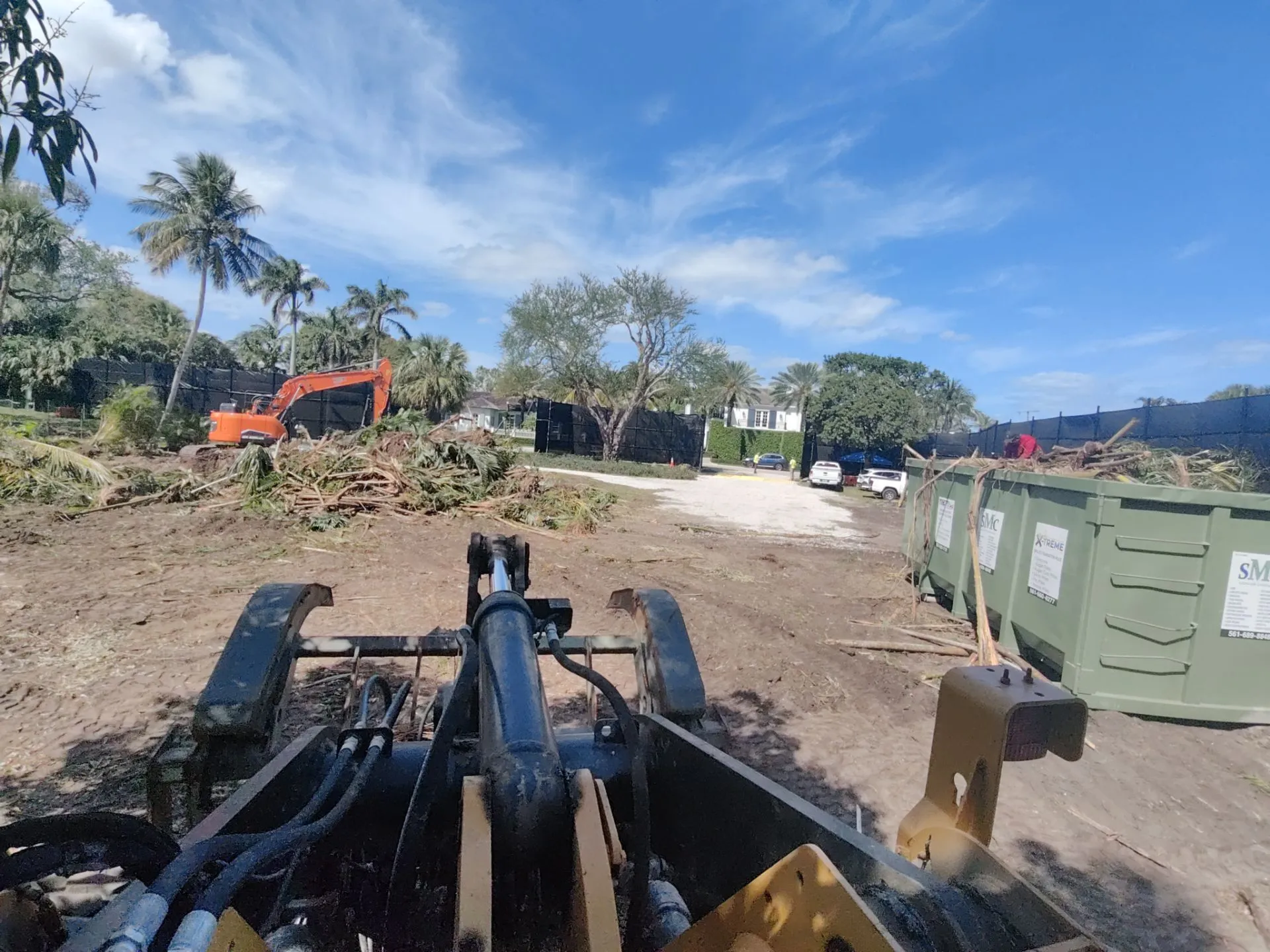 Image of grapple to load and clear vegetation into dumpster